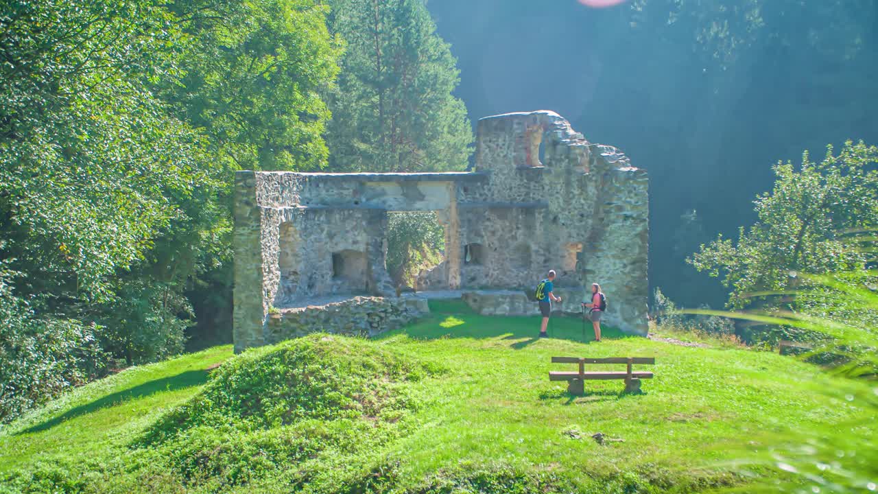 Two young hikers visiting Pistrov castle on top of a beautiful hill in Vuzenica, Slovenia