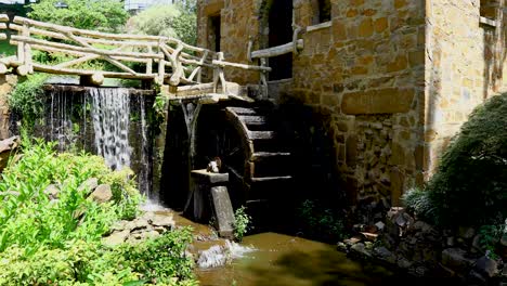static video of the old mill in little rock arkansas. a water wheel and waterfall can be seen