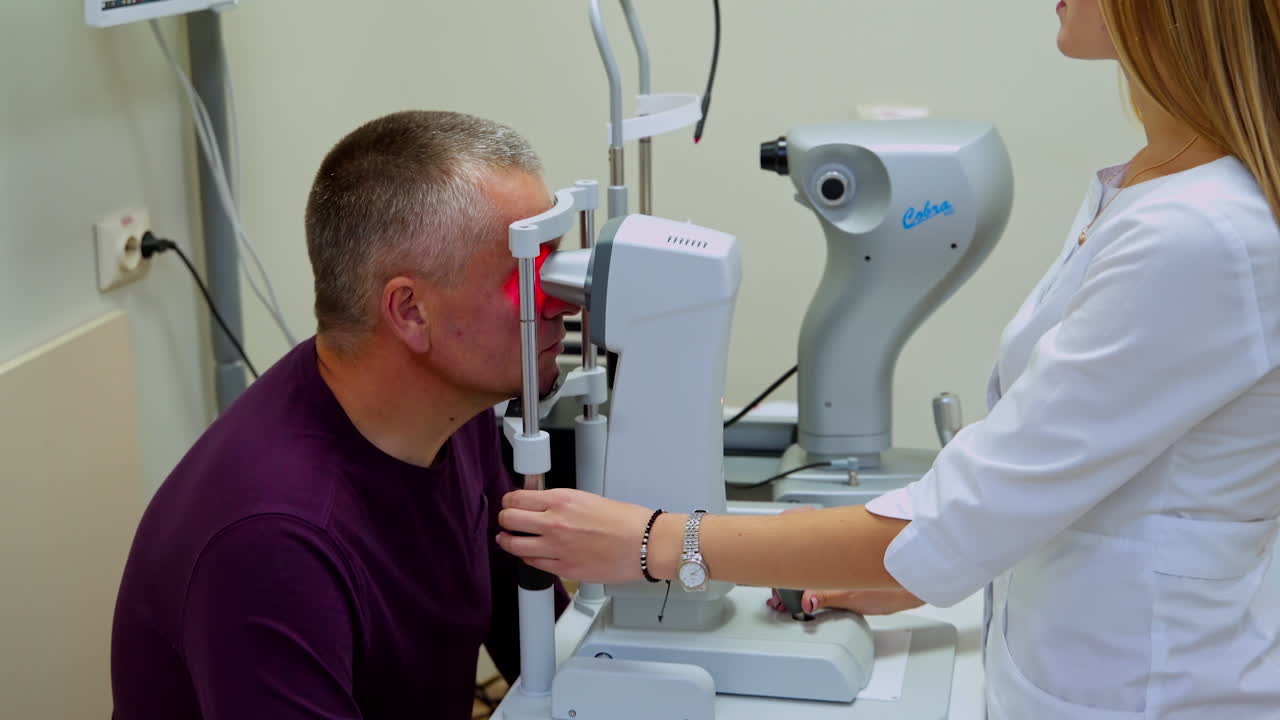 Man checking the eye vision. Female doctor ophthalmologist checking eye vision of man