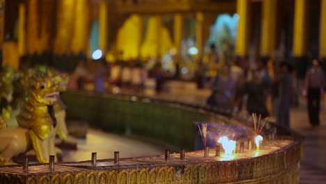 candles burn at a burmese temple