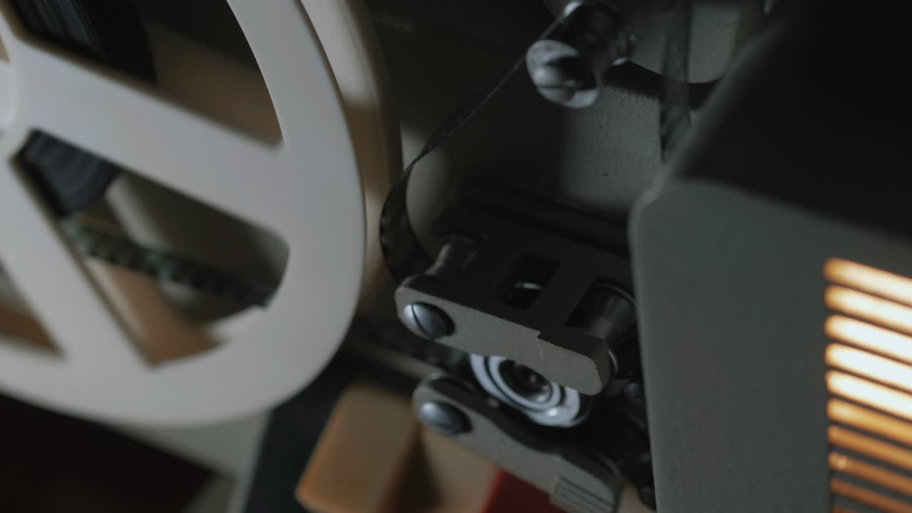 film projector on a black background with dramatic lighting and selective focus. Retro film production accessories still life. Concept of film-making. Smoke effect on background