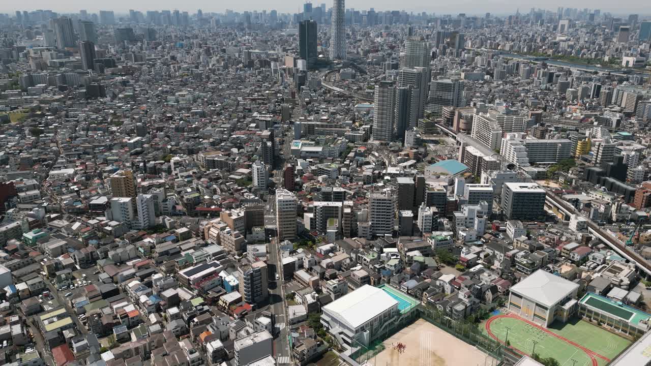 Aerial Scenic Urban Drone Footage of a neighborhood, streets and buildings in the Capital City of Tokyo, Japan on a Sunny Day