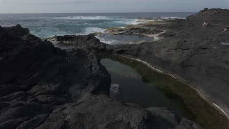 rocky shoreline with tidal pools at mosteiros, azores, sao miguel, capturing the rugged beauty of volcanic rocks and the atlantic ocean