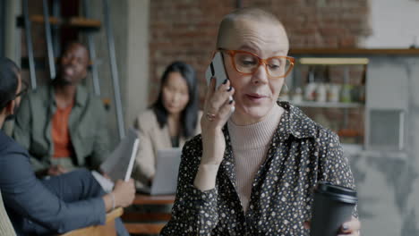 businesswoman on phone call in busy office