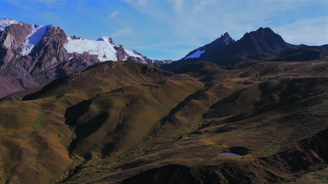 Peruvian Andes mountains Hatun Ritty Hatun Rit'i glacier aerial drone morning sunrise blue skies clouds Red Valley Rainbow Mountain Vinicunca Huancavelica Region Qoyllur Rit'i rainy season circle left