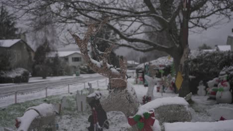 close up footage of a reindeer christmas lawn ornament in a snowy residential neighborhood