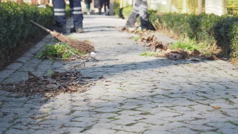 street sweeper cleaning cobblestone path in park