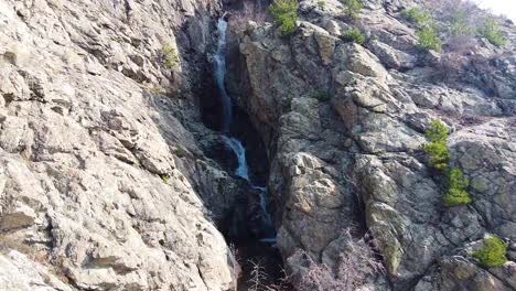 flying-towards-a-waterfall-in-the-Balkan-mountains-near-the-town-of-Sopot,-Bulgaria