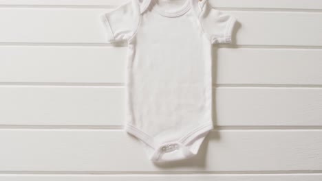 video of close up of white baby grow on white background