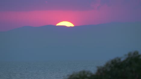 evening sun hiding behind the mountains