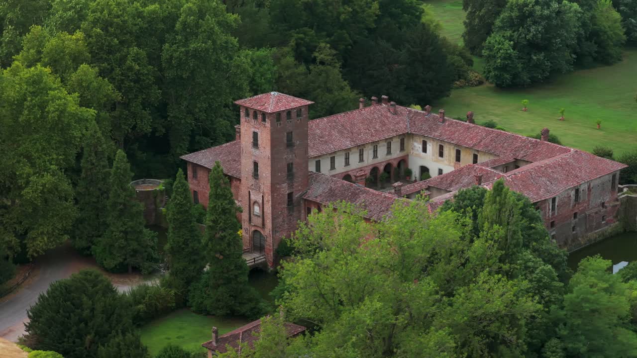 Aerial view of historic Borromeo Castle surrounded by lush green park. For travel or history content, Peschiera Borromeo, Lombardy, Italy