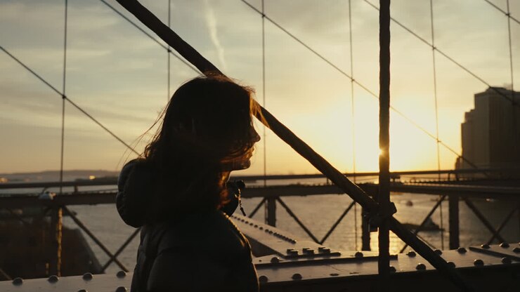 Woman on Brooklyn Bridge at Sunset