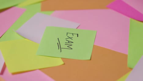 Education-Concept-Of-Revolving-Sticky-Notes-With-Exam-Written-On-Top-Note-1