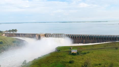 Revealing-Drone-Shot-of-Sluice-Gates-on-a-Dam-Wall-Open,-Vaaldam-South-Africa