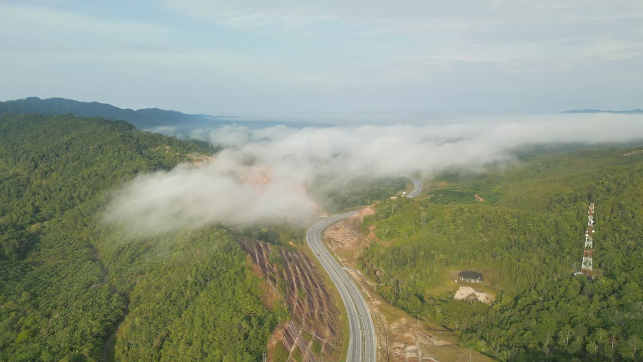 Foggy Sunset Early Morning During Raining Season Asian Tropical Rain forest, with Mountain And Green Valley,Palm Oil Farm,Sarawak,Borneo.