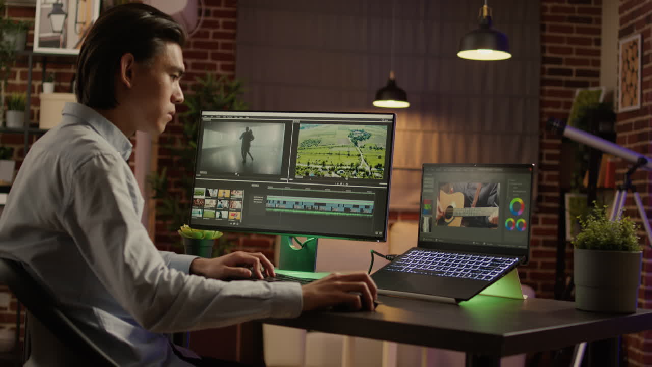 A man is video editing on his computer