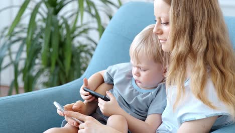 mother and toddler playing on smartphones
