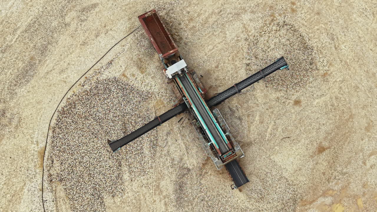 Large machine works on sand in construction site near desert