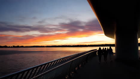 vibrant sunset with silhouettes on a modern bridge
