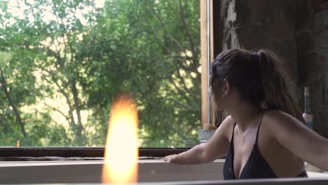 4K-Young-attractive-female-relaxed-having-a-fancy-bath-in-a-jacuzzi-with-big-green-nature-window