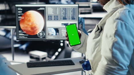 astronaut using green screen smartphone to text friends