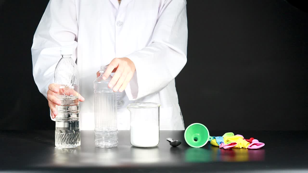 A child conducts a science experiment, mixing vinegar and baking soda to inflate a balloon, demonstrating a chemical reaction