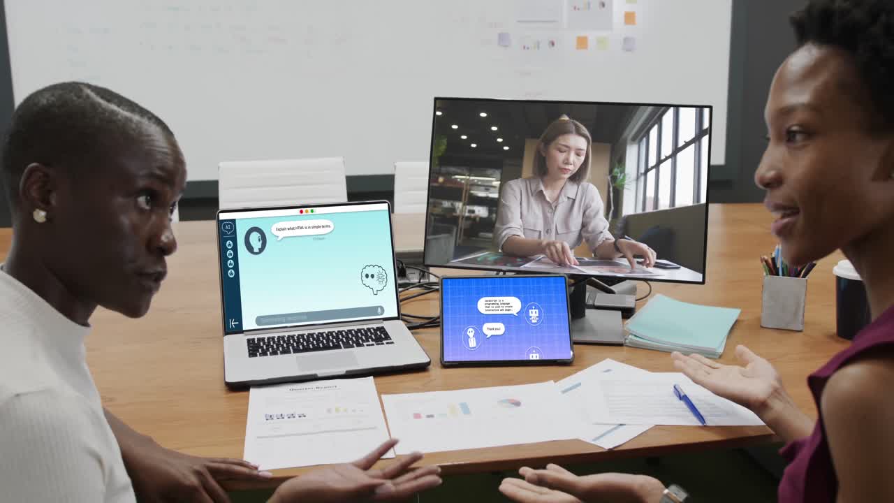 Diverse business people having video call and using laptop with digital chat on screen in office