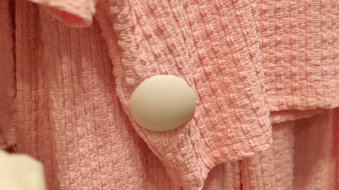 Close-up of Pink Textured Fabric with White Button