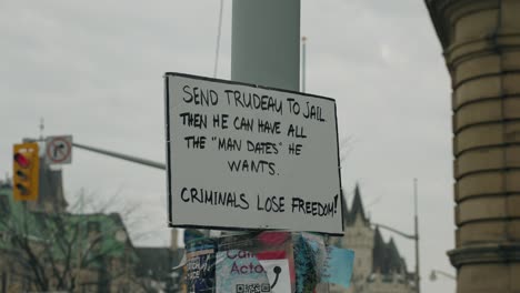 placard with handwritten message "send trudeau to jail" posted along the street during freedom convoy protest in ottawa, canada