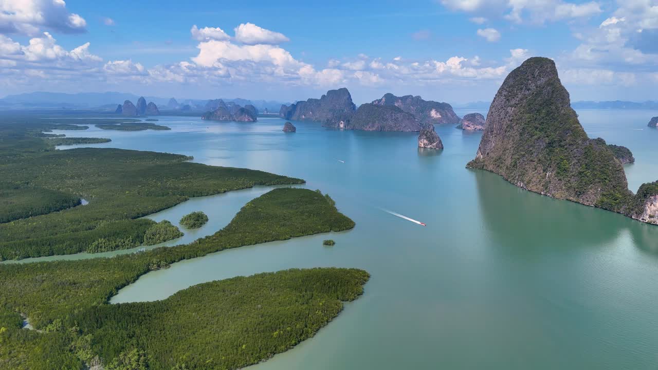 Drone footage captures stunning aerial views of Phang Nga Bay, showcasing lush mangroves, turquoise waters, and iconic limestone formations
