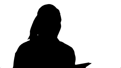 silhouette attractive young woman using a touchscreen tablet, reading and talking to a camera