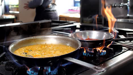 Chef-preparing-seafood-risotto-in-restaurant,-close-up,-Mediterranean