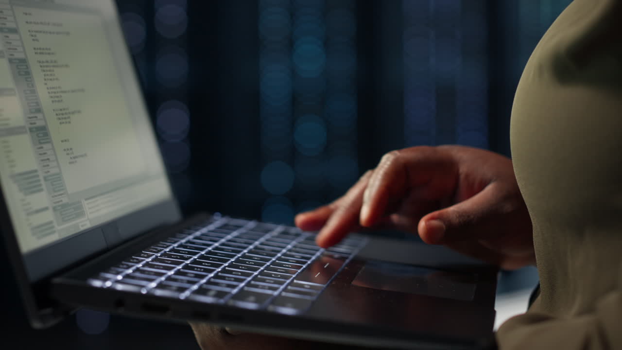 Data center system administrator using laptop to ensure error free rigs