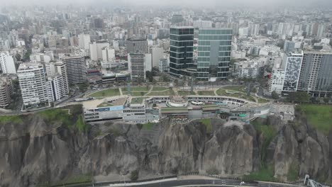 aerial flight to shopping mall perched on cliff top in miraflores peru