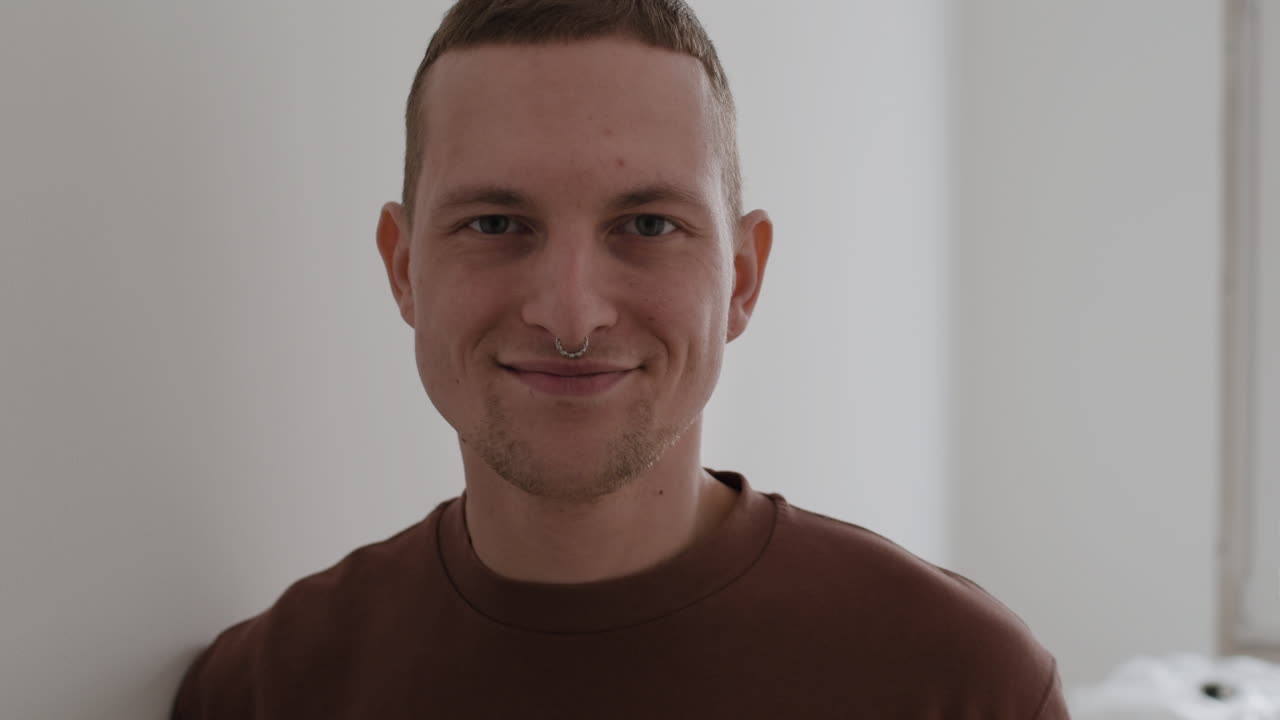 Young Man with Nose Ring Painting a Wall