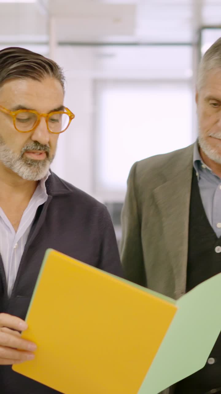 Businessmen walking while reading a financial report on paper