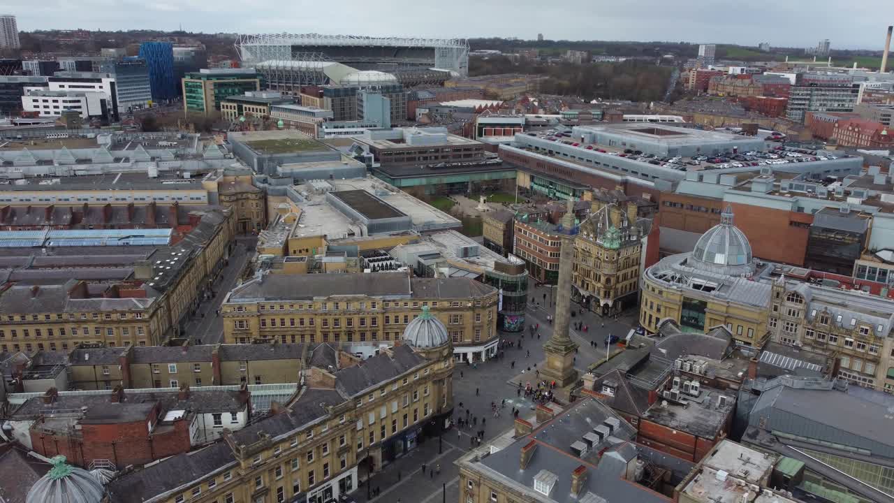 Cinematic aerial view of centre of Newcastle with Grey's Monument and St James' Park towering in background - Newcastle Upon Tyne