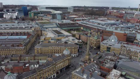 Cinematic aerial view of centre of Newcastle with Grey's Monument and St James' Park towering in background - Newcastle Upon Tyne