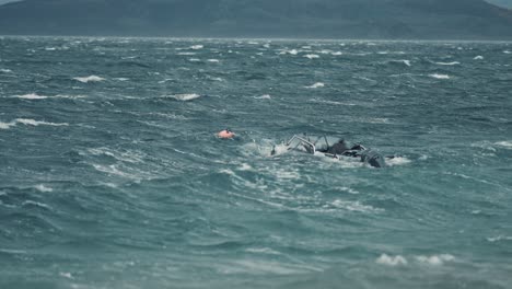 A-small-motorboat-tied-to-a-buoy-battling-strong-wind-and-powerful-waves-in-the-fjord