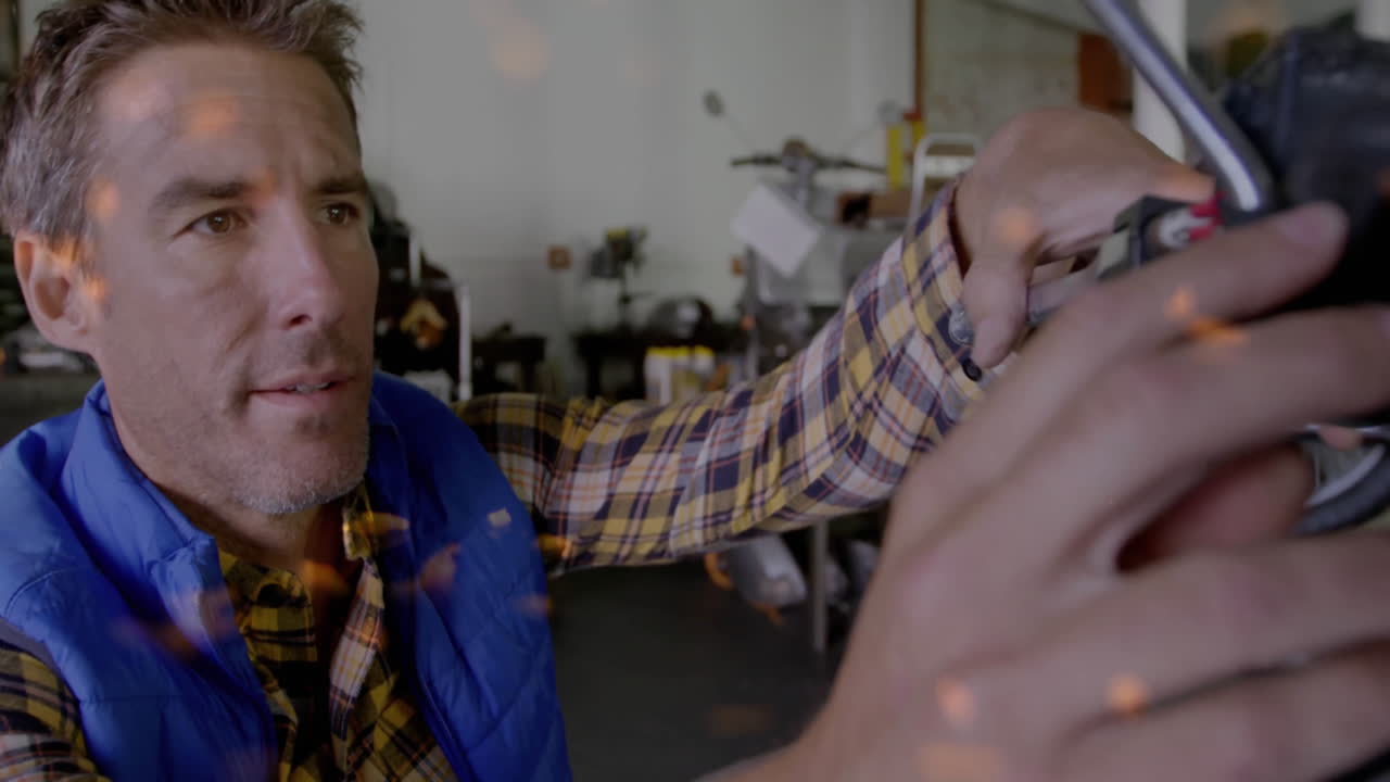 Adult mechanic adjusting handlebars in automotive garage, with animated data points on controls