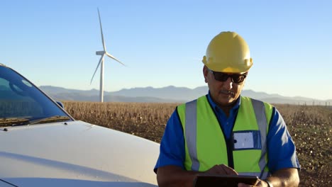 male engineer using digital tablet near car 4k