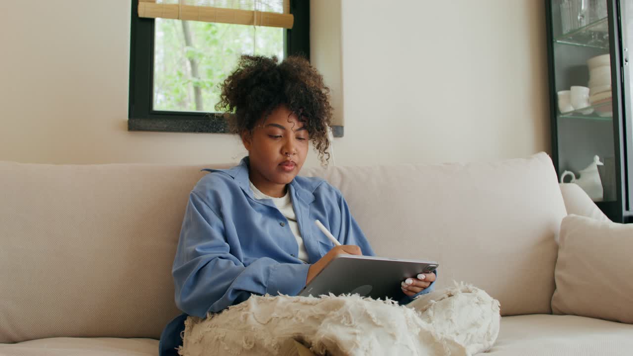 Woman Drawing on Tablet at Home