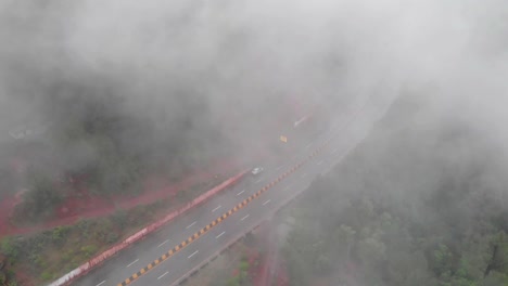 aerial birds eye view of muree expressway through dense fog