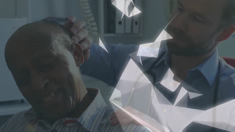 animation of shapes over caucasian male doctor with patient