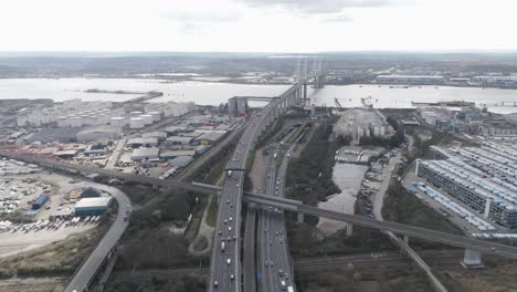 aerial view of dartford crossing cable-stayed bridge carrying multi-lane traffic across the river thames through industrial zones and key urban transport routes
