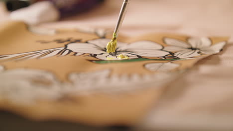 painting an outlined drawing of a flower