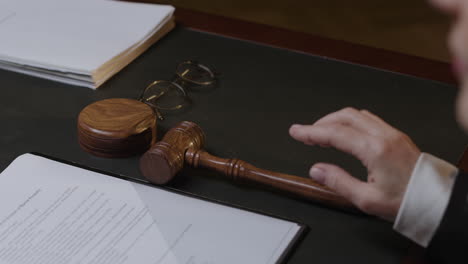 judge striking gavel in courtroom