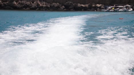 waves from a boat moving in the ocean, camera onboard handheld