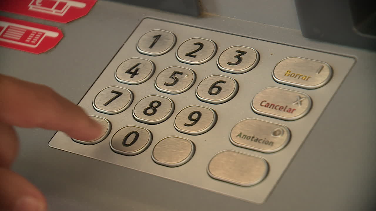 Person Entering PIN in ATM