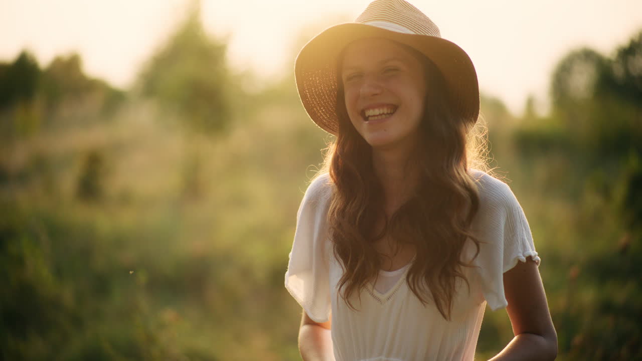 Dreamy girl photographing tall meadow grass
